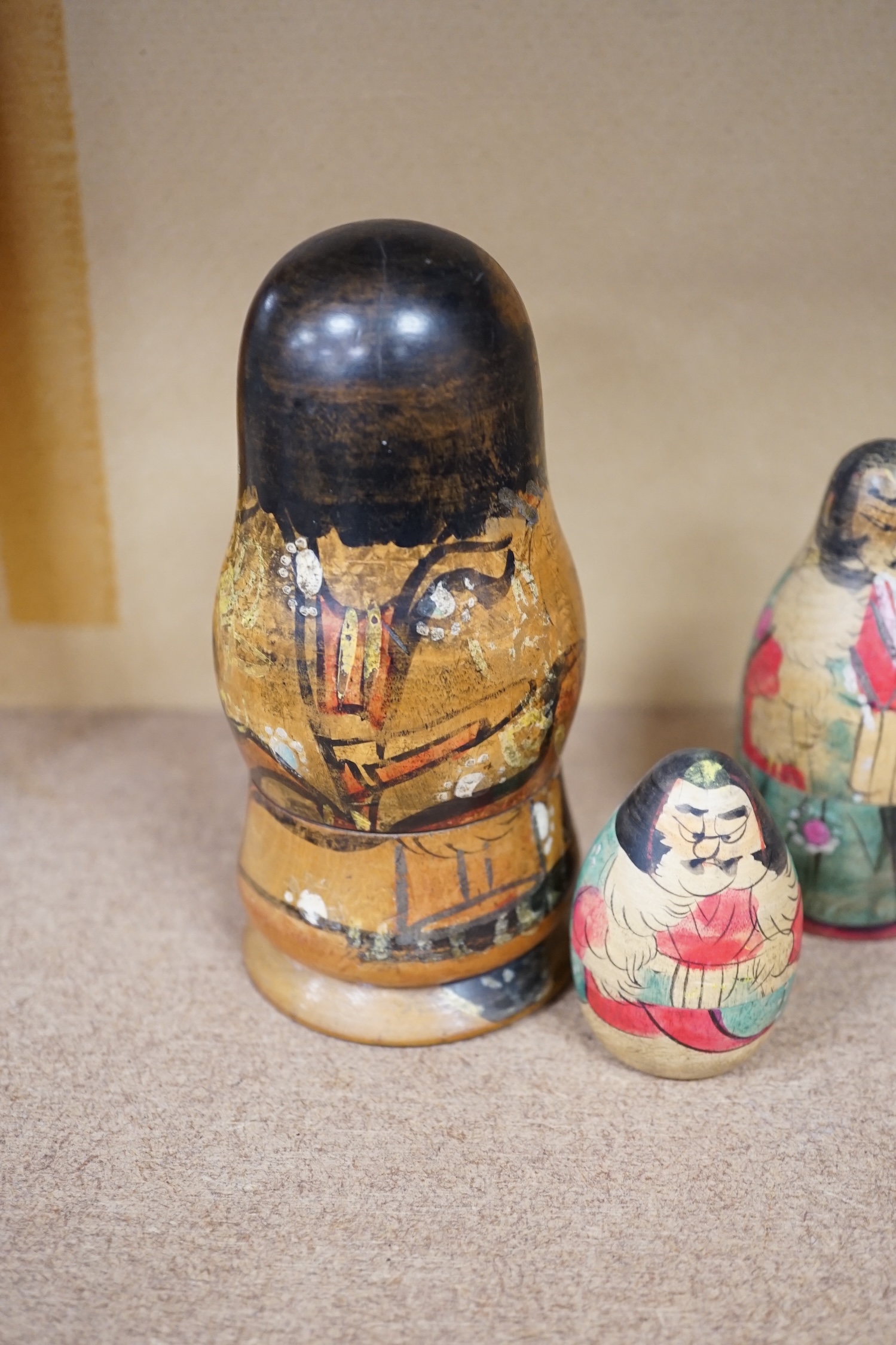 A nest of three Japanese decorated Russian dolls. Condition - fair